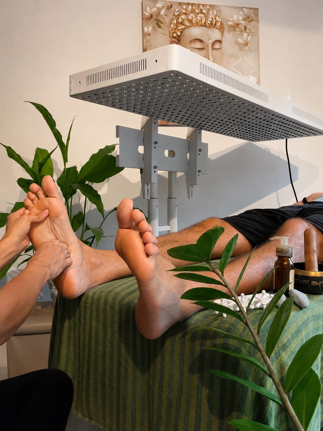 A Vitalara practitioner applying focused pressure during a reflexology session